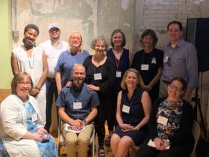 A picture of a group of 3 men and 8 women at what appears to be a conference.