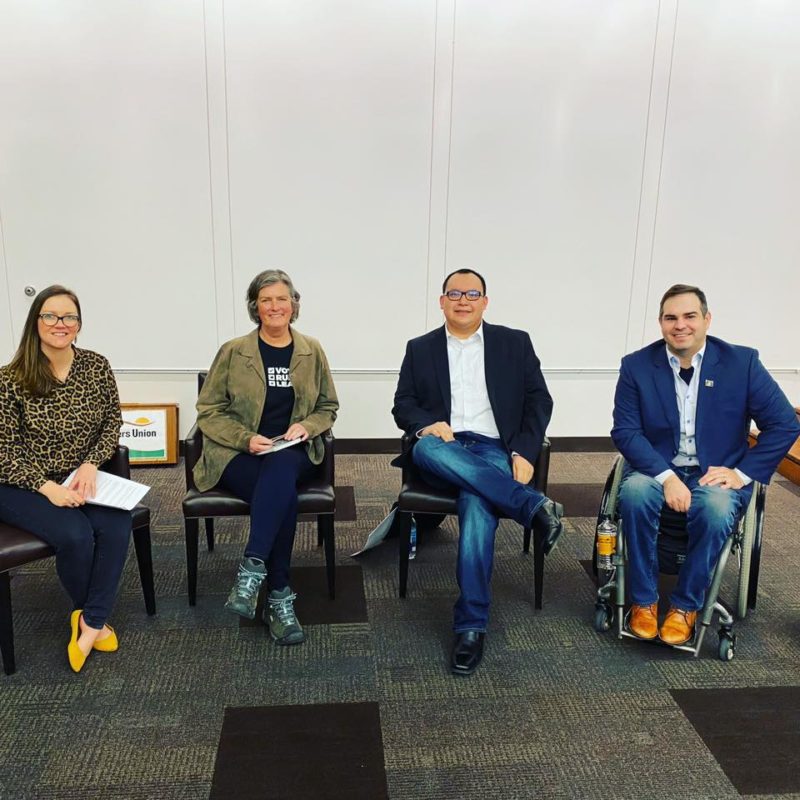 A picture of four people together for a conference at the Farmers Union in North Dakota.