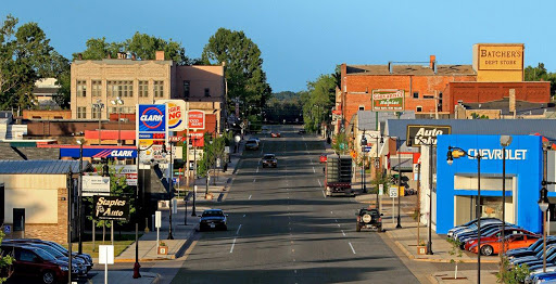 A picture of Downtown Staples, MN showcasing the street with the Chevrolet business, Clark gas station, and Burger King.