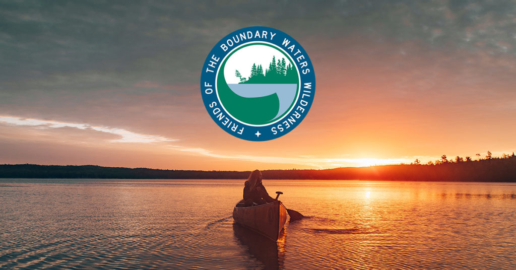 Person canoeing on lake at sunset with the Friends of the Boundary Waters Wilderness Logo above.