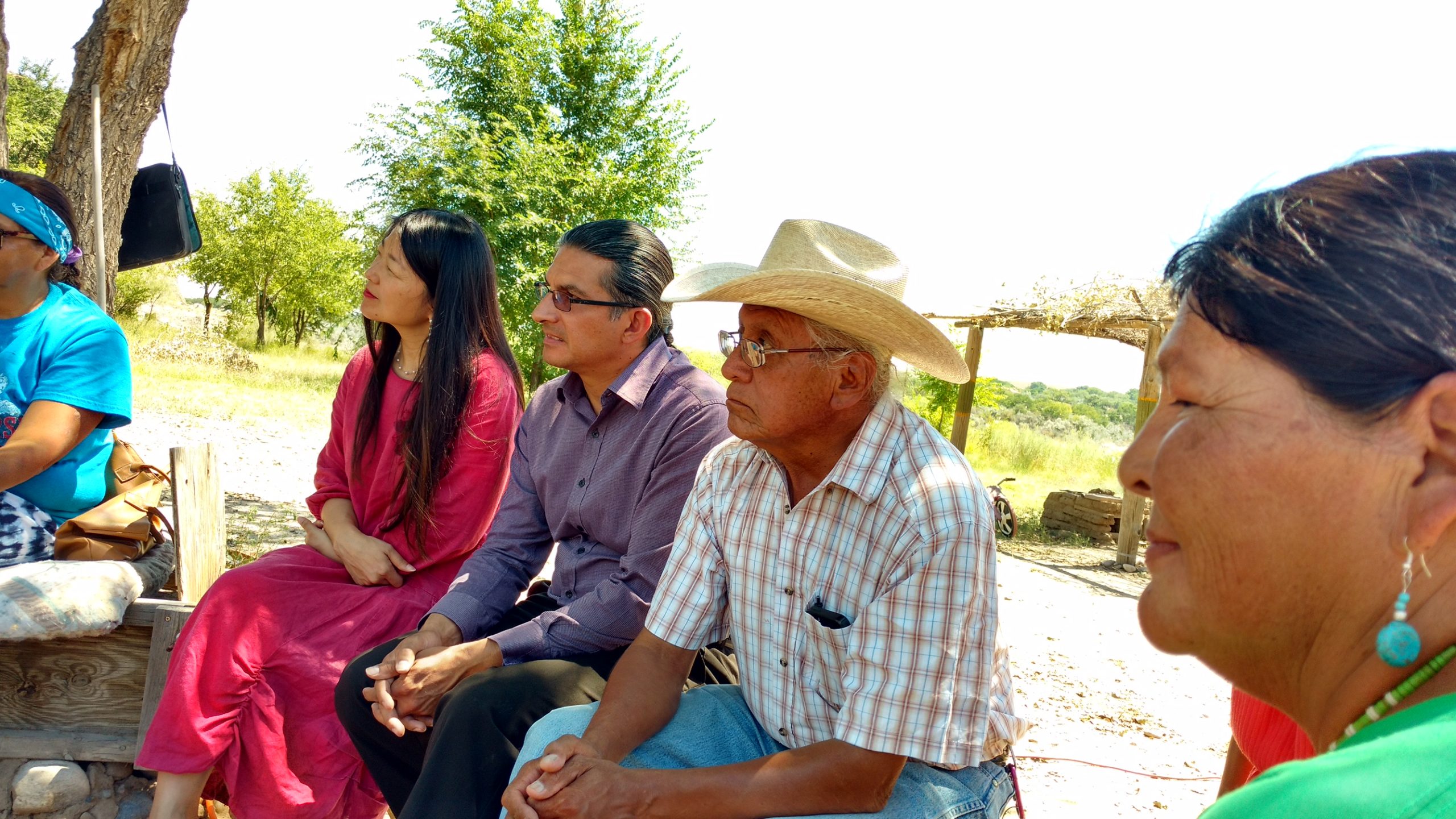 A picture of members of the Navajo nation sitting outside.